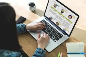 Woman in front of a laptop searching on a directory
