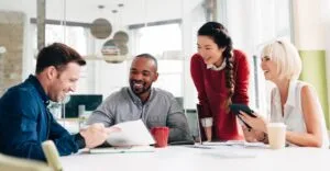 Header-group8 - AccessAlly Four people looking at work documents