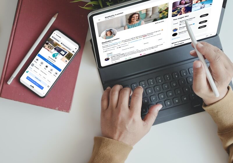 an iPhone 11 showing the AccessAlly Facebook page and an iPad with Nathalie Lussier's Twitter
