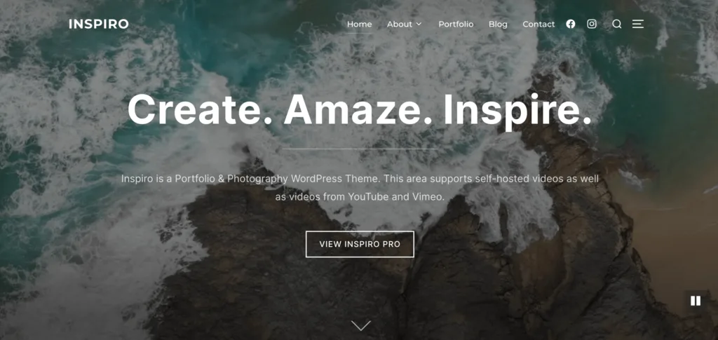 Inspiro Lite demo site with white sans serif font on top of a shadow-overlain image of the ocean waves crashing on rocks.