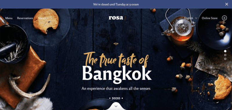 Rosa2 Lite demo site, with a dark background with cookies, acorns, and herbs. Typography is gold and white.