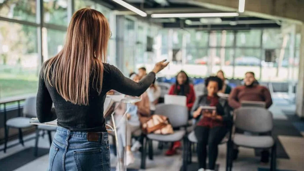 A woman teaches a small group of attendees